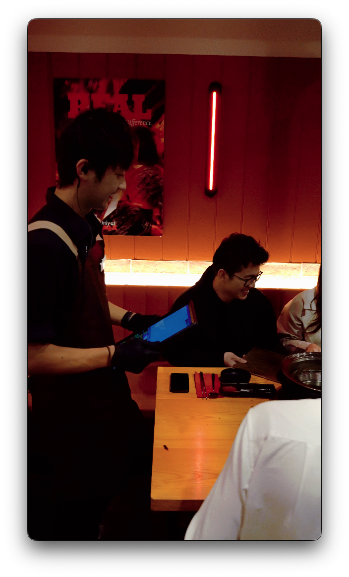 Staff member sharing a laugh with guests at the table